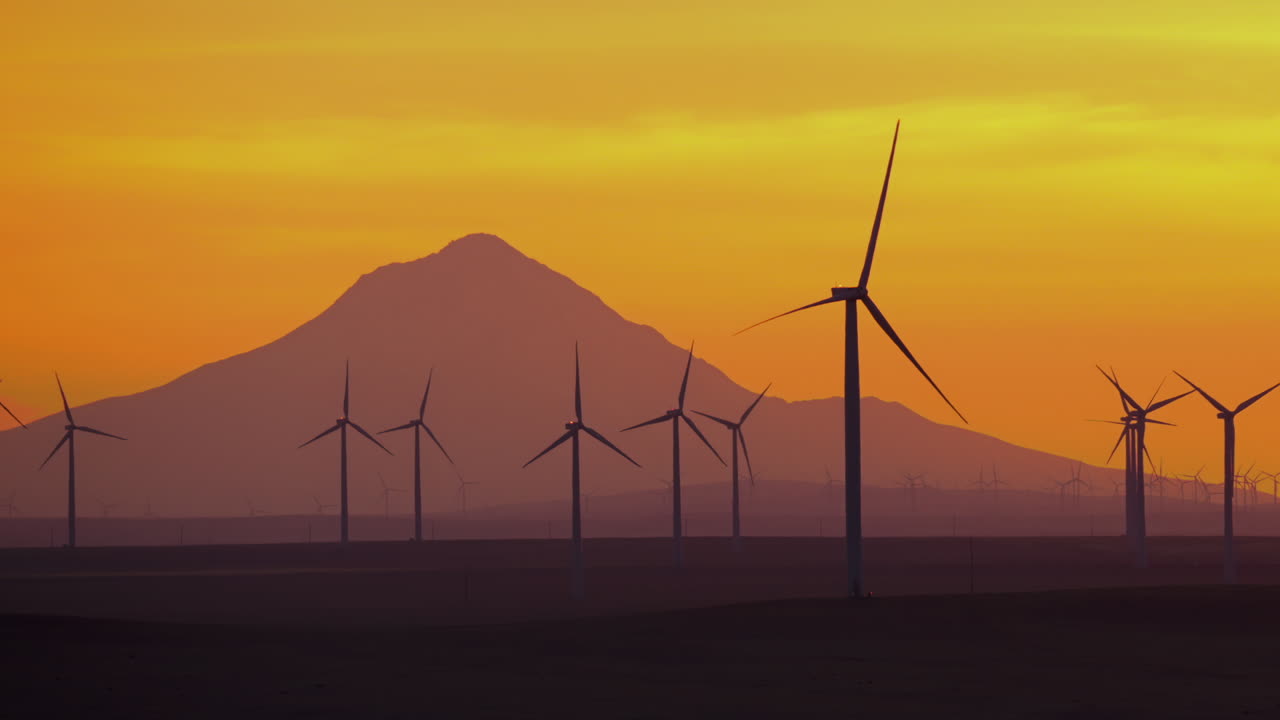 Wind Turbines Rotor Blades Spinning Slow At Dusk With Mount Hood In The Background In Oregon, USA. - slow panning
