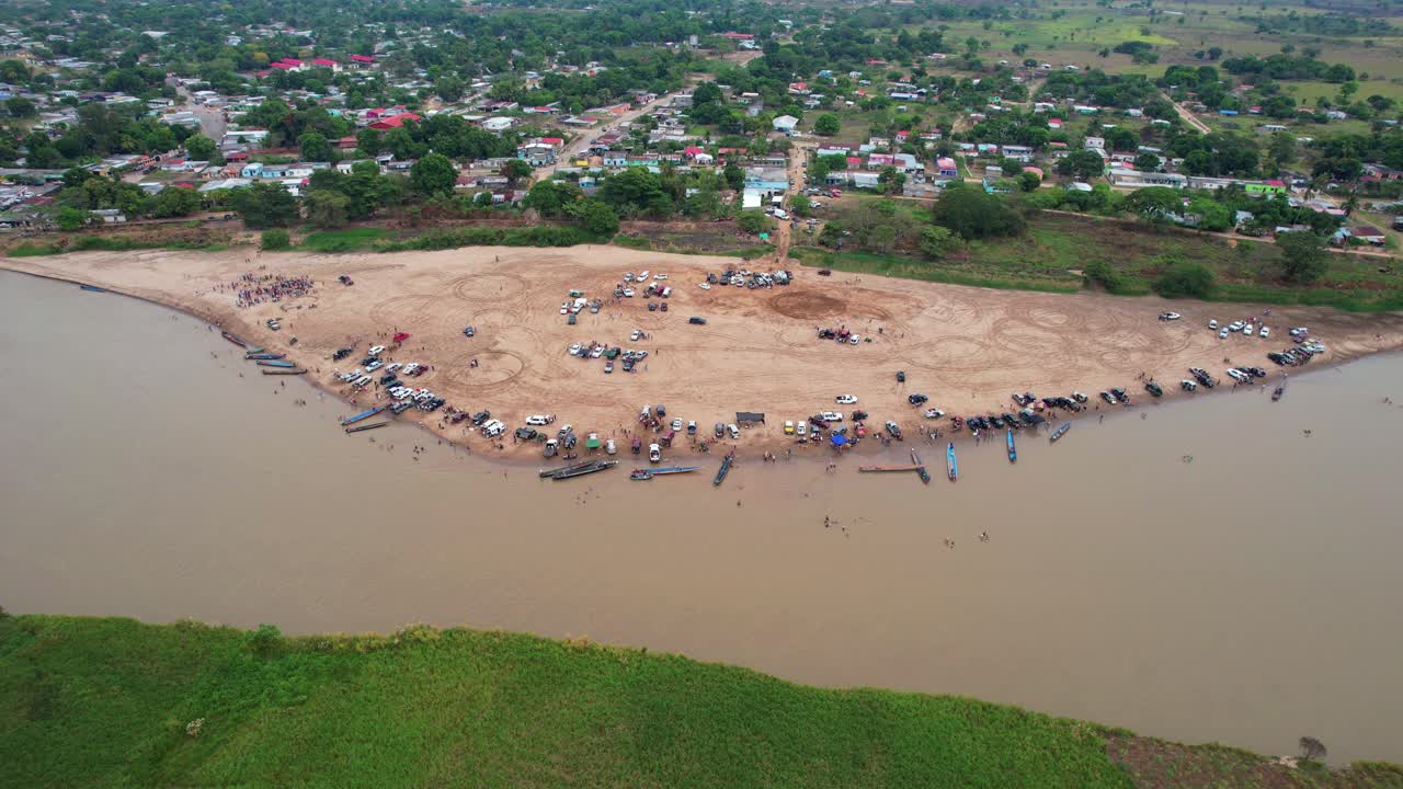 The beach by the river in elorza, with people and boats on the shore, aerial view