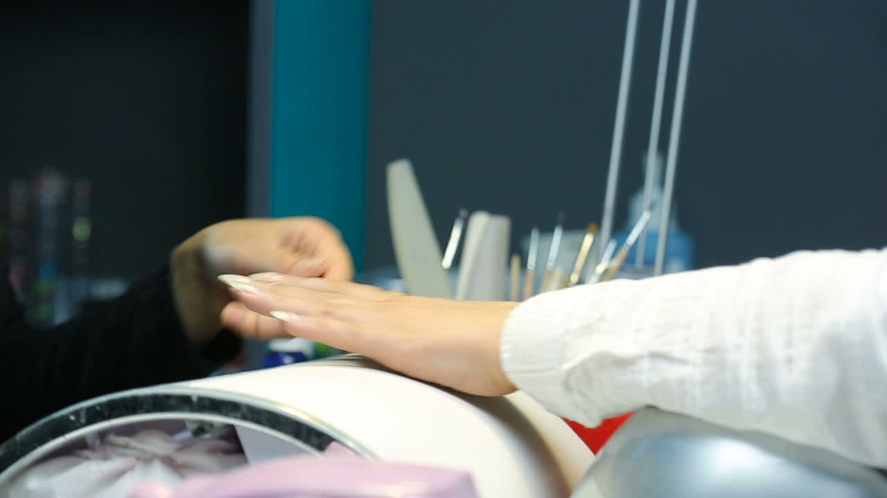 Manicure for woman. Closeup shot of a woman in a nail salon receiving manicure by beautician