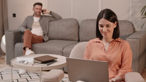 woman typing and talking to blurred man