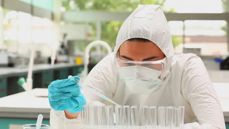 Scientist-pouring-blue-liquid-in-test-tubes