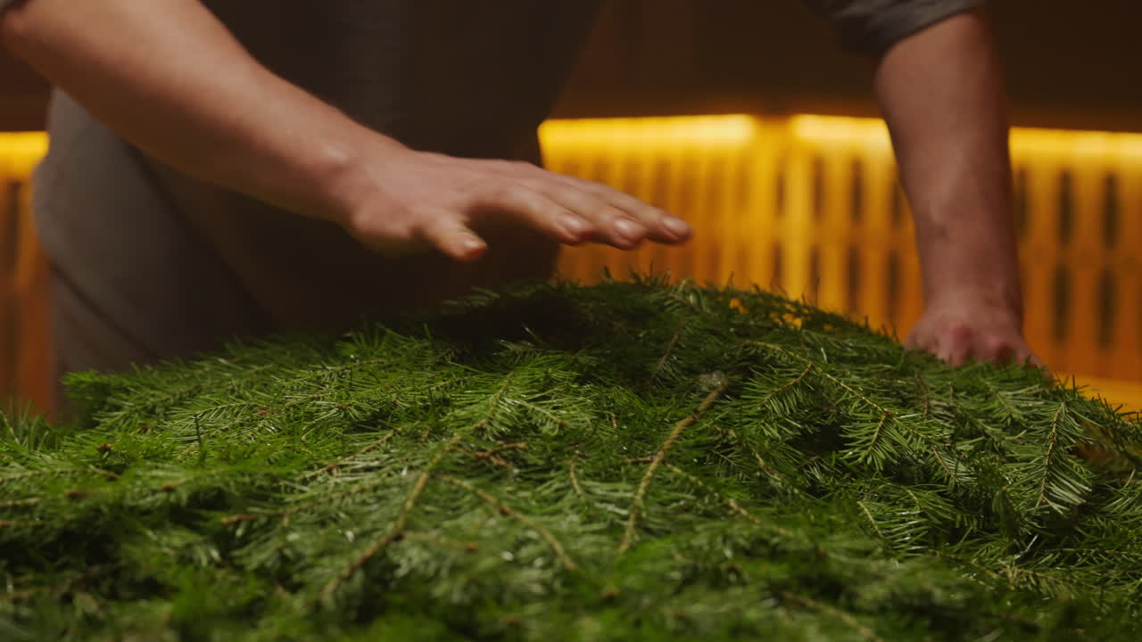 Person preparing a Christmas wreath
