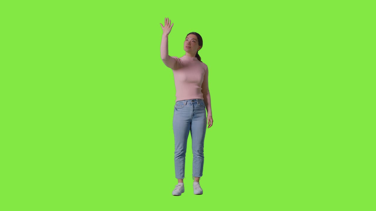 Full Length tudio Shot Of Woman Looking All Around And Interacting With VR Environment Against Green Screen