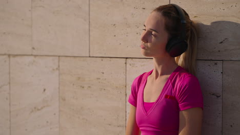 woman relaxing outdoors with headphones