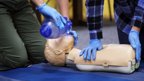 exercise for life saving in emergency. demonstration of cpr on manikin. teaching method pressing on the chest on a dummy in the medical room.