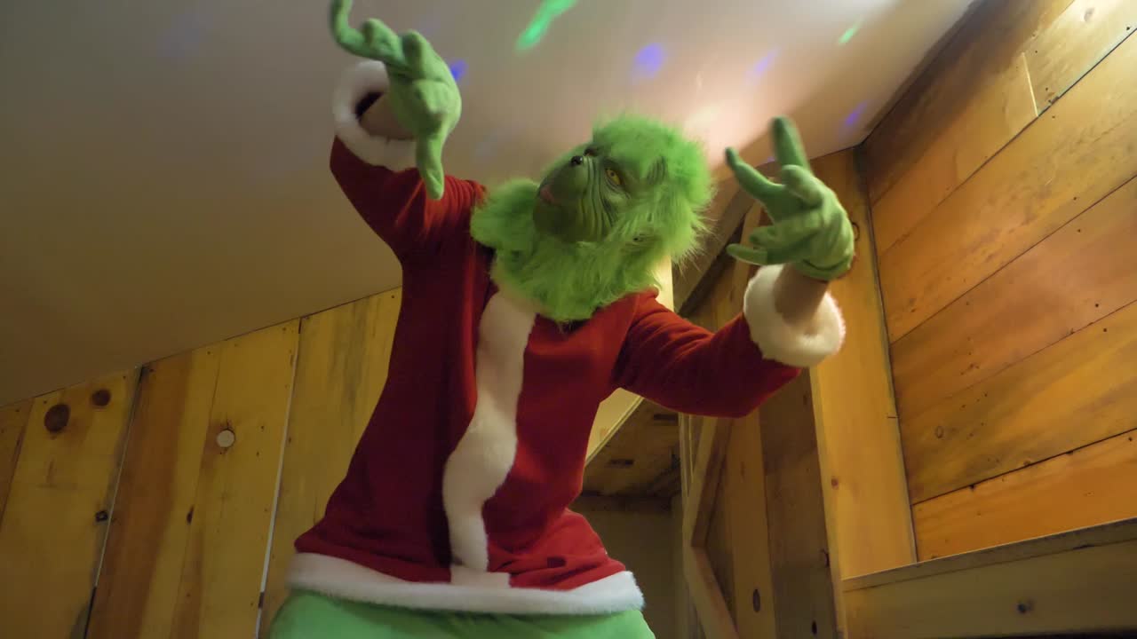 Premium stock video - Grinch christmas character dancing in slow-mo