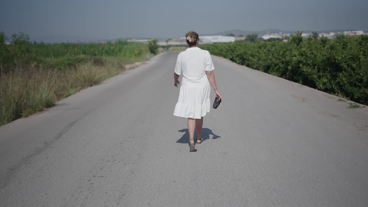 Woman walking on a country road