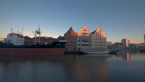 long ship at motlawa river gdansk poland, building around golden hour shot