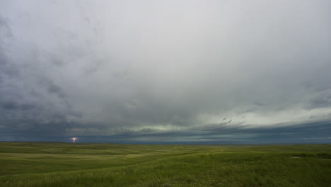 skies darken as storm clouds move in over rolling green hills