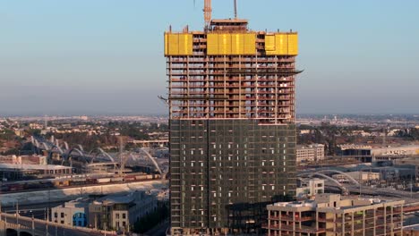 skyscraper construction site and neighborhood in east los angeles - rising aerial reveal