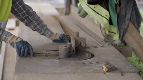a construction worker bends steel rebar by hand on a building site, showing skill and precision in preparing reinforced steel for concrete.perfect for documentaries, education, and construction videos