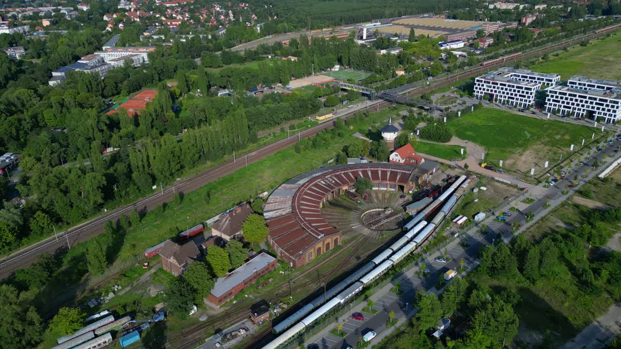 historic steam locomotive shed and trains depot with surrounding urban city Berlin Germany landscape, industrial heritage. Fantastic aerial view flight drone top down Above view