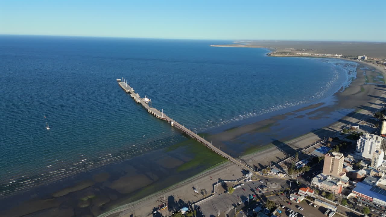 The Muelle Comandante Luis Piedra Buena, pedestrian tourist promenade in the city, shore, ocean, sea, pan shot with copy space