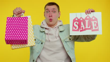 happy student man showing sale inscription banner text, advertising discounts low holidays prices