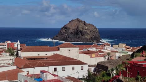 view over rooftops of garachico town towards the rock in the ocean