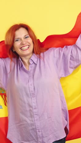 happy woman waving spanish flag