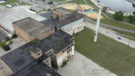 Drone-Mavic-Air-2-descending-over-an-old-decrepit-factory-on-a-rainy-day