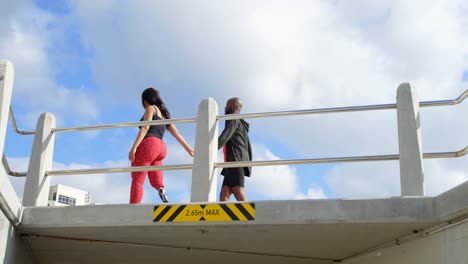 couple walking with hand in hand near railing 4k