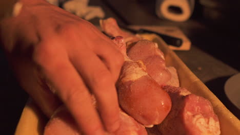 Closeup-seasoning-and-marinating-of-raw-chicken-legs