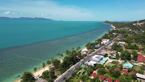 aerial view of mae nam coastline in koh samui with tropical homes and beach