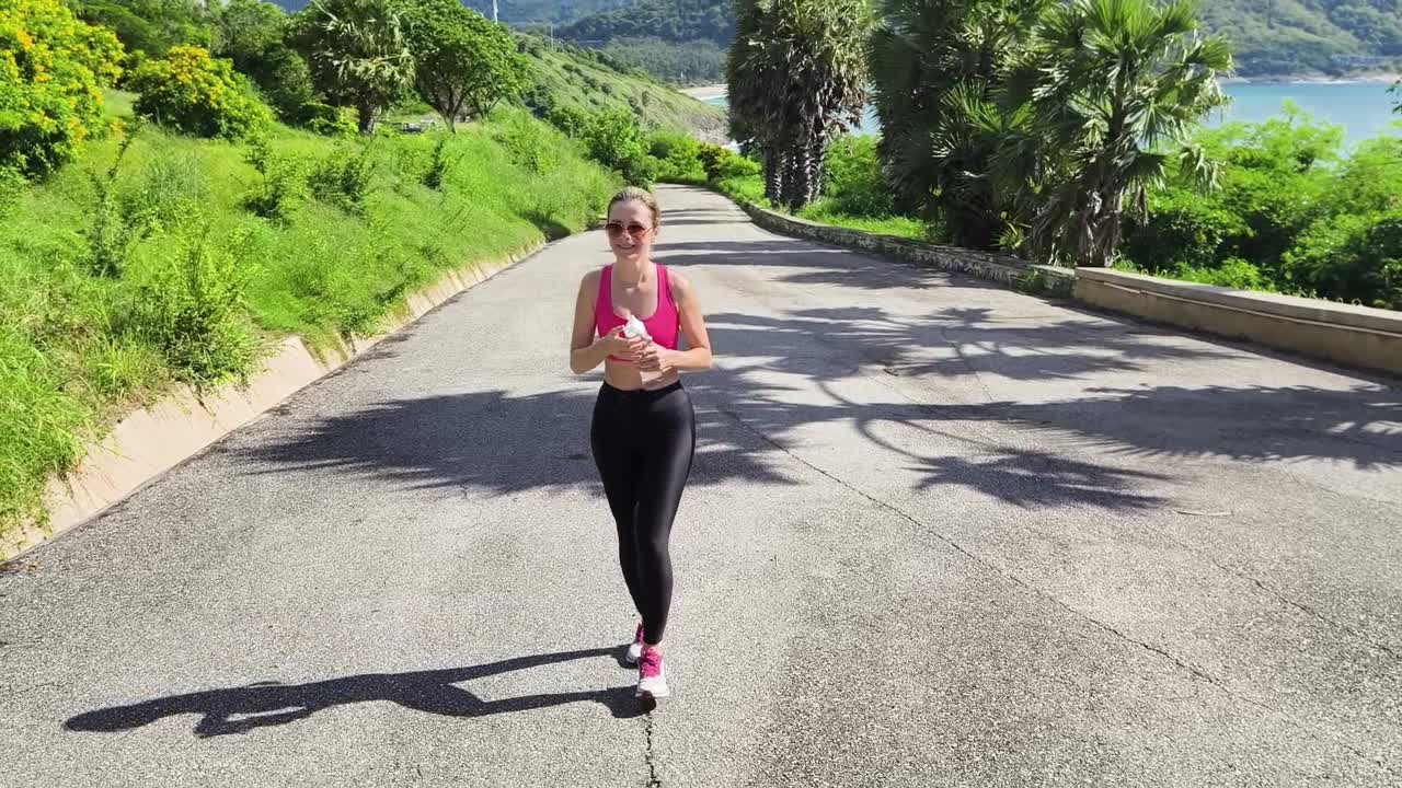 Donna che cammina su una strada panoramica lungo la spiaggia