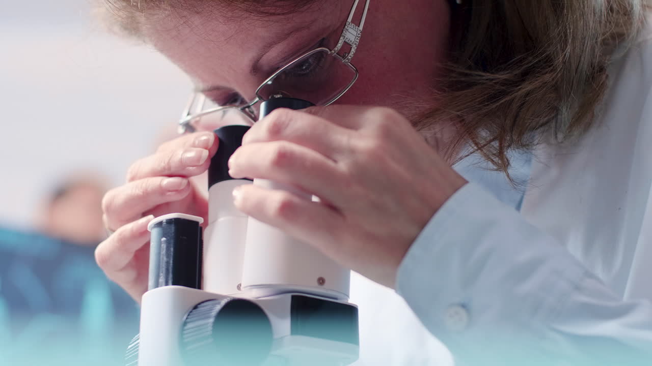Scientist Examining Sample with Microscope