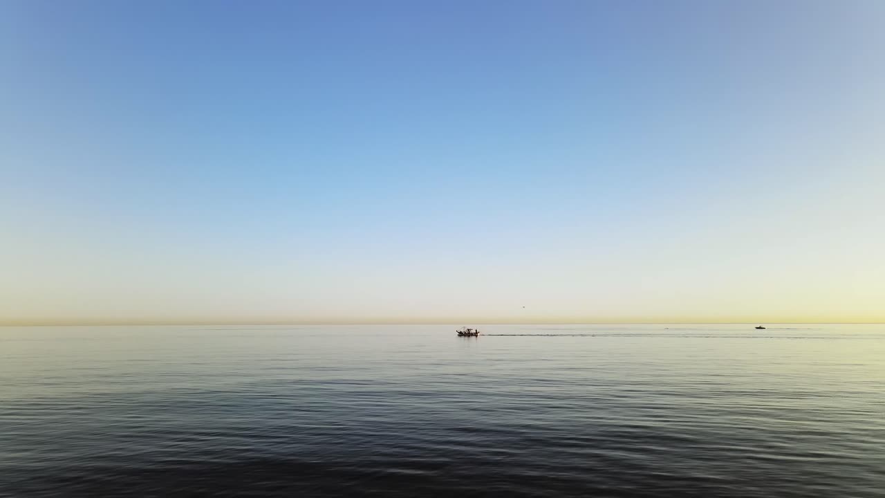 Horizon view of waves with a boat passing at the distance