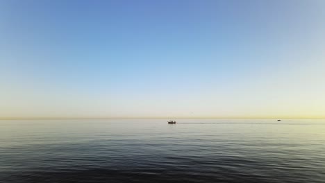 horizon view of waves with a boat passing at the distance