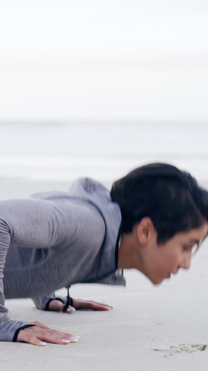Woman Doing Push Ups on a Sandy Beach