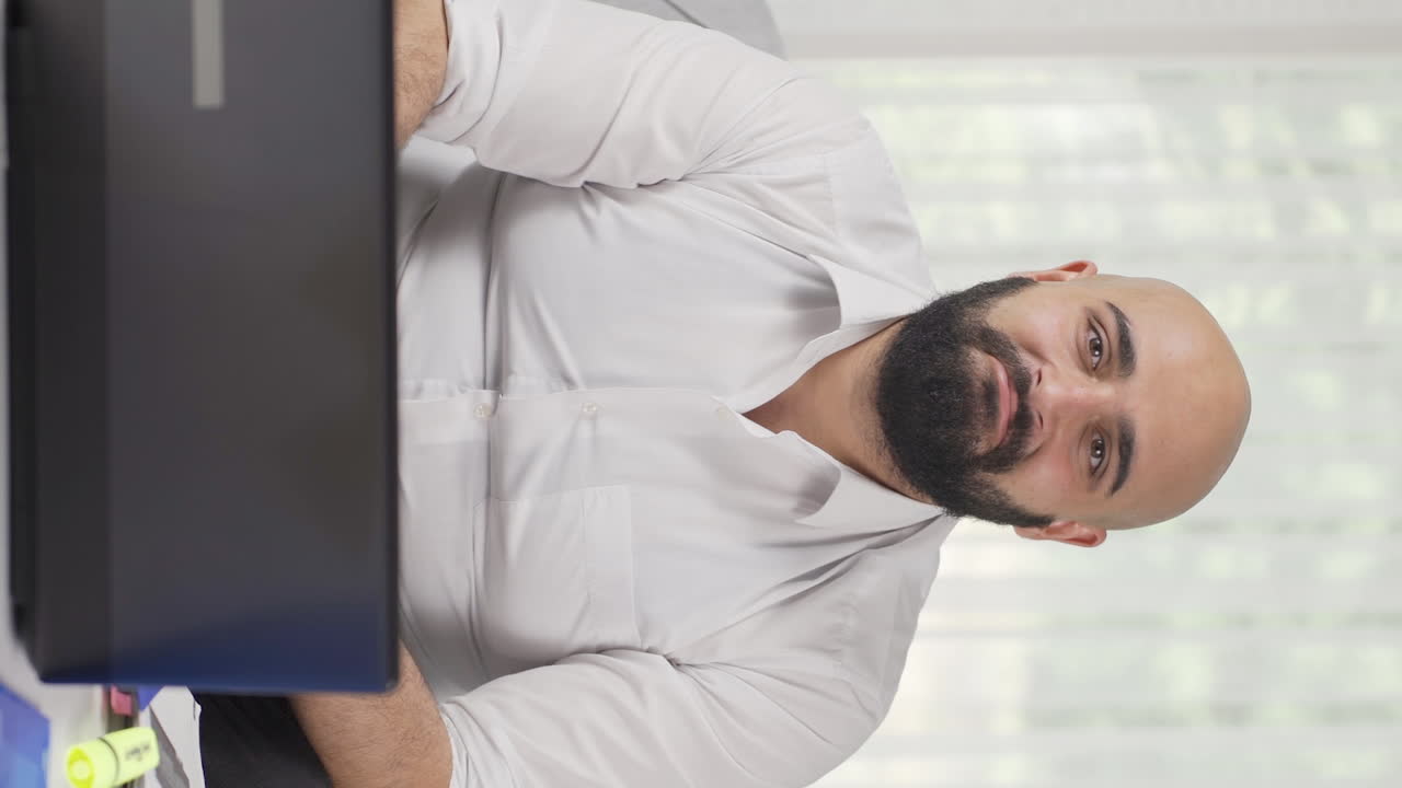 Vertical video of Home office worker man says wow to camera.