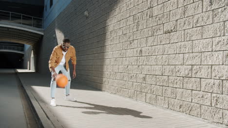 man dribbling basketball in urban setting