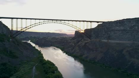 a 4k fly-over drone shot of perrine bridge, a 1,500 foot long bridge, spanning over the snake river in twin falls, idaho