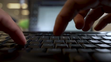 Horizontal-angle-of-fingers-typing-on-computer-keyboard-in-office-environment