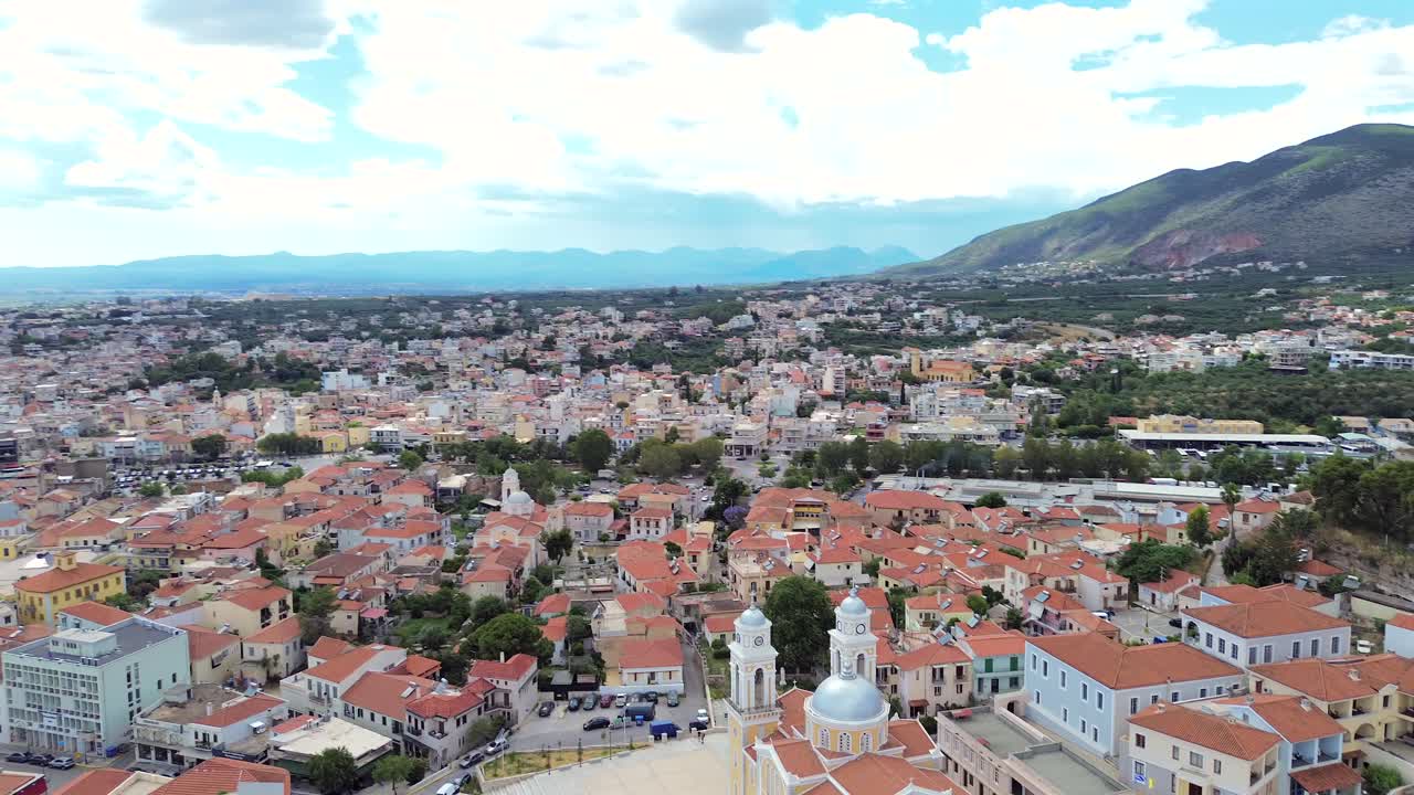Aerial high angle, bird's eye view orbital footage showcasing Historical center of Kalamata, tilt up reveal cityscape 4K