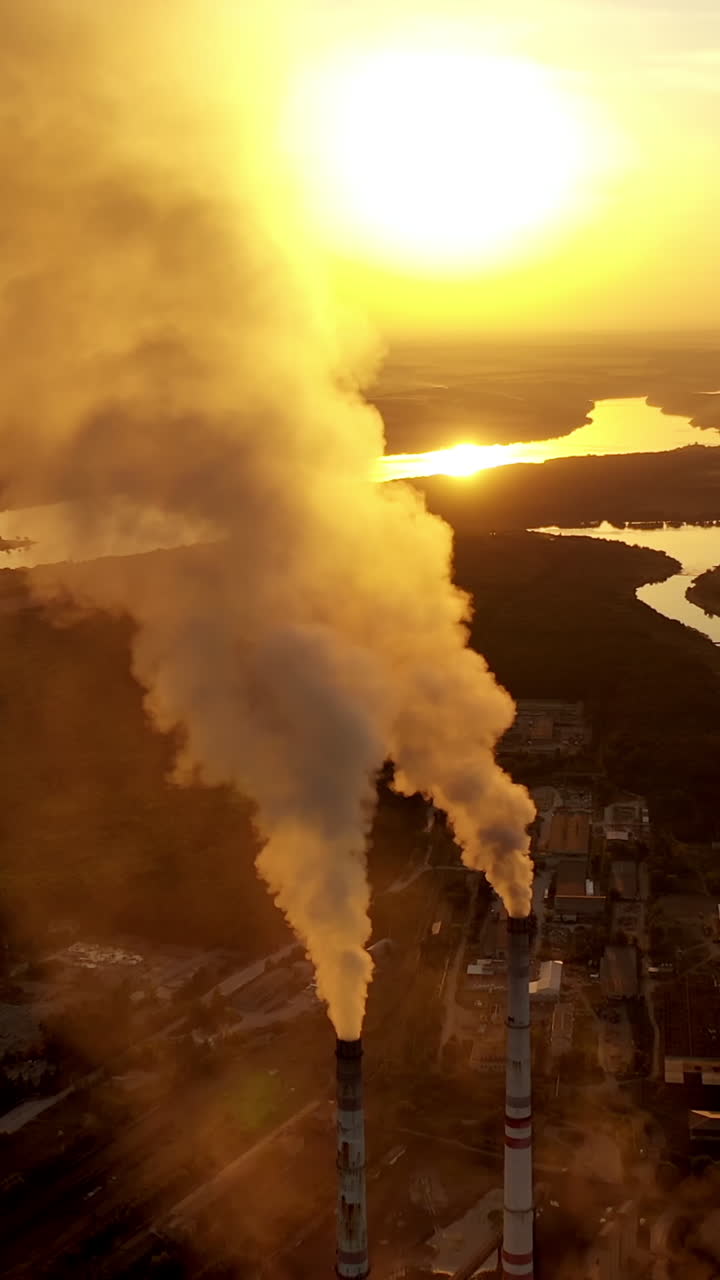 Old smokestack of factory. Pollution and smoke from chimneys of factory Vertical video