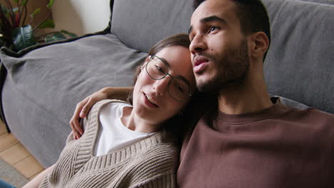 Young-couple-sitting-on-the-carpet