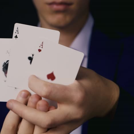 the magician does tricks with playing cards