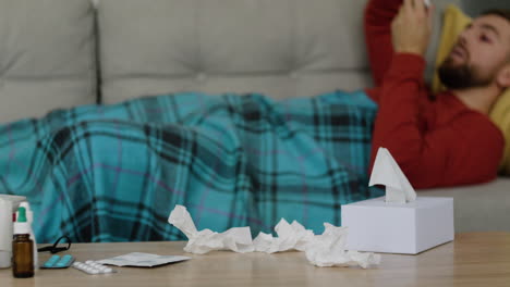 Sick-man-laying-on-the-sofa