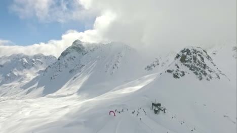 bird's eye view of wintry snow-capped mountains on which a ski lift stops