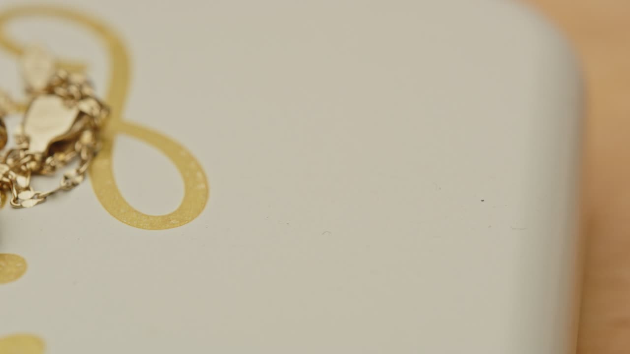 Panning to a beautiful golden necklace with a diamond in the locket