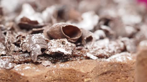 close-up of chocolate cake with shavings and powdered sugar