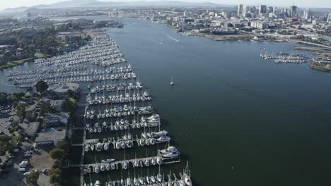 pan up across a large marina and sailboats parked in their slips