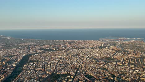 Aerial-view,-pilot-point-of-view-of-Valencia-city,-Spain,-in-a-hot-summer-day-with-some-haze-and-uncloudy