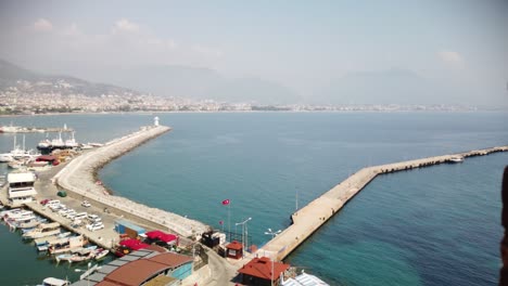 view of alanya and harbour at a sunny day. shore of mediterranean sea and historical alanya shipyard in turkey.