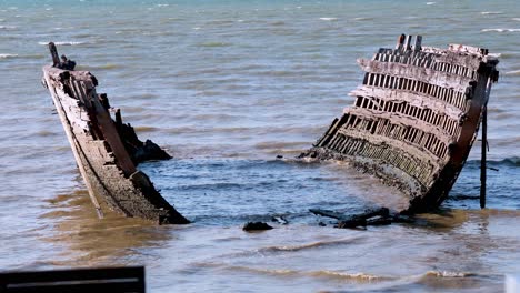 old boat remains in pattaya's sea waves