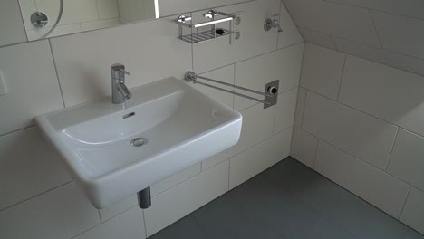 modern small bathroom with white tiles and chrome fixtures