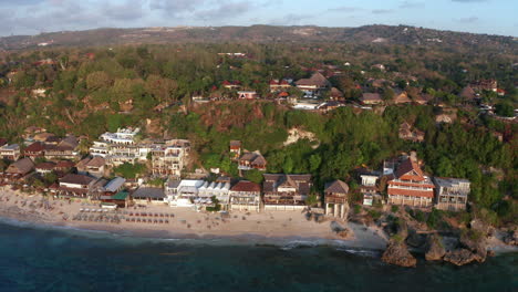 cinematic drone fly filming bingin beach resort hill for surfers adventure