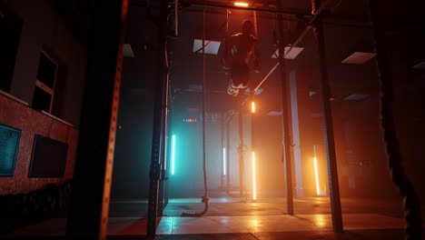 strong bodybuilder muscular athletic man gymnastics exercise using rings enjoying intense muscle workout muscular sportsman bodybuilding practice in gym slow motion. orange blue neon light