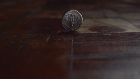 coin spinning on wooden floor after flipping