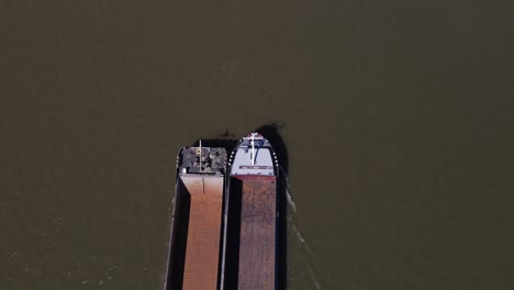 bird's eye view of empty cargo boat entering frame, cologne germany